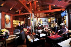 a living room with people sitting on couches at Salana Boutique Hotel in Vientiane