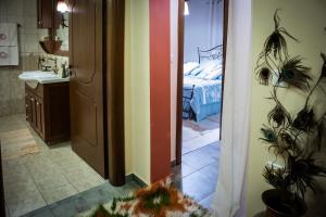 a bathroom with a room with a bed and a mirror at Villa in the mountain in Ioannina