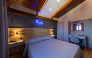 ein Hotelzimmer mit einem Bett, einem Schreibtisch und einem Fenster in der Unterkunft Hotel Vogue in Licola