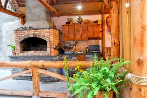 un soggiorno con camino in pietra in una casa di VAN Garden a Vanadzor