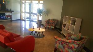 a living room with a table and two chairs and a table sidx sidx at MK Express Hotel in Aracaju