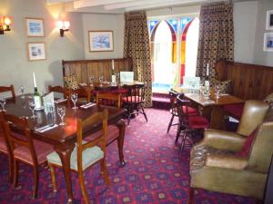 a dining room with wooden tables and chairs at Royal Oak Inn in Lostwithiel