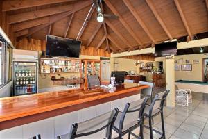 a bar in a restaurant with chairs around it at Hotel Garant & Suites in Boca Chica