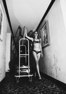 a woman in a bikini standing next to a ladder at Petit Ermitage in Los Angeles