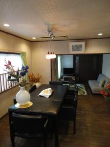 a dining room and living room with a table and chairs at Kyoto Inn Higashiyama in Kyoto