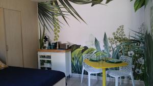 a room with a table and chairs and plants at Le Studio 54 in Honfleur +15 photos