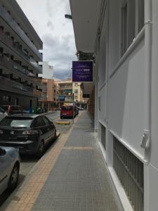 a street with cars parked on the side of a building at Hotel Boutique Centro BBB Auto check in in Benidorm