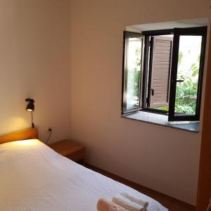 a bedroom with a bed and a window at Holiday home Marija in Karlobag