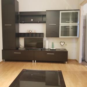 a living room with a large black entertainment center at Holiday home Marija in Karlobag