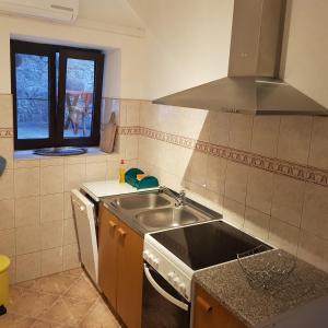 a kitchen with a sink and a stove at Holiday home Marija in Karlobag +38 photos