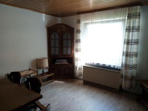 a living room with a large window and a table at Haus Stefanie in Niederburg