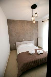 een slaapkamer met een bed met twee handdoeken erop bij Gala House in Kavala