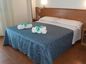 Postel nebo postele na pokoji v ubytování Hotel Leuco'