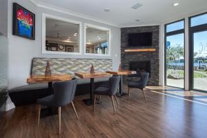 a dining room with two tables and a fireplace at Inn on Long Lake in Nanaimo
