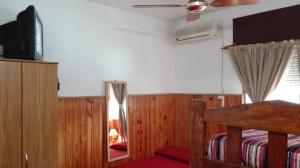 a bedroom with a bed and a tv and a mirror at Hotel Residencial Casal in La Paz