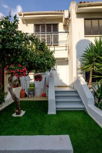 a house with a yard with stairs and grass at FatCow Beach House 43 in Larnaka