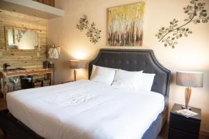 a bedroom with a white bed and a desk at Arrowhead Mountain Lodge in Cimarron