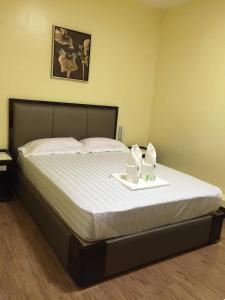 A bed or beds in a room at Meaco Royal Hotel - Plaridel