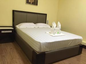Ένα ή περισσότερα κρεβάτια σε δωμάτιο στο Meaco Royal Hotel - Plaridel