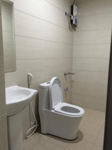 a bathroom with a toilet and a sink at Meaco Royal Hotel - Plaridel in Plaridel