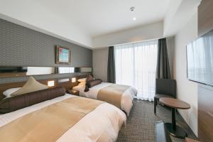 Postel nebo postele na pokoji v ubytování Hotel Miyahira 