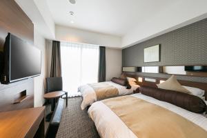 Postel nebo postele na pokoji v ubytování Hotel Miyahira 