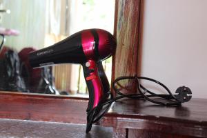 a hair dryer sitting on a table in front of a mirror at Pasan Guest in Ella