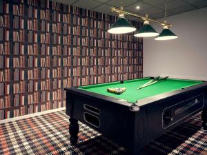 a room with a pool table in front of a wall at Mercure Orange Centre A7/A9 in Orange