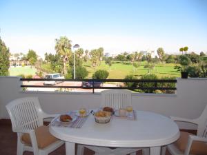 a white table with a bowl of food on a balcony at Life Apartments Costa Ballena in Costa Ballena