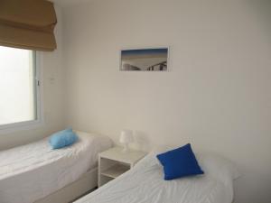 two beds with blue pillows in a room at Life Apartments Costa Ballena in Costa Ballena +109 photos