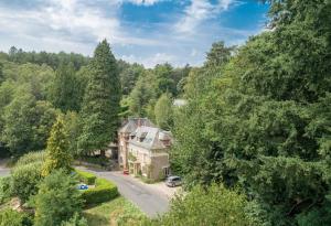 an aerial view of a house in the woods at B&B Le Saut de la Bergère in Aubazines