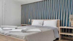 a bedroom with a large bed with towels on it at Villa Maraki in Agia Paraskevi