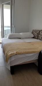 a large bed in a room with a window at Apartment Vila Mirela in Krimovice