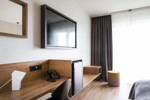 a living room with a television and a coffee table at Hotel Berg by Keflavik Airport in Keflavík