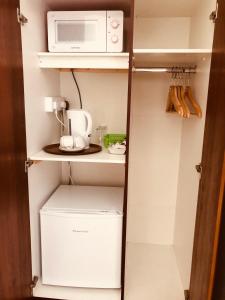 a small kitchen with a microwave and a refrigerator at Five Glens Inn in Manorhamilton