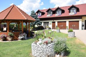 a house with a garden and a gazebo at Urlaub am Bauernhof Familie Rößler vlg. Spor in Pöls