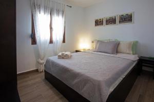 a bedroom with a bed with two towels on it at Antoni's House Makri in Alexandroupoli
