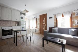 a living room with a couch and a table at Antoni's House Makri in Alexandroupoli