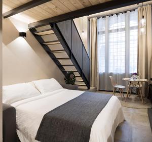 a bedroom with a large bed and a staircase at Borgo De Chiari in Bologna
