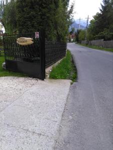 a fence with a frisbee on it next to a road at Pensiunea Belvedere in Bran