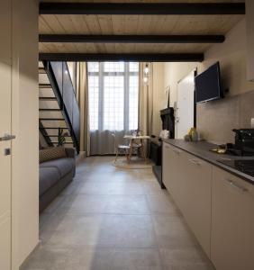 a kitchen and living room with a couch and a table at Borgo De Chiari in Bologna +7 photos