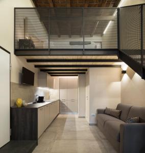 a living room with a couch and a kitchen at Borgo De Chiari in Bologna