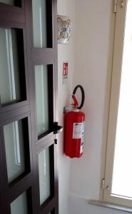 a fire hydrant on the wall next to a door at La Maison de mémé in Cetara
