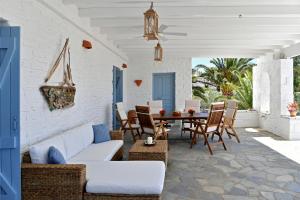 a patio with a couch and chairs and a table at Kolymbithres Seaside Villa in Kolympithres