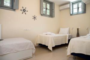 Cama ou camas em um quarto em villa aneme Spetses