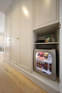 a refrigerator filled with drinks in a white kitchen at Greta Residence in Zadar