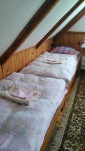 two unmade beds sitting in a room with at Chalupa Severak in Janov nad Nisou