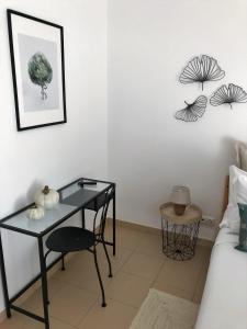 アルマカオ・デ・ペラにあるCASA YETI - Beach Houseの黒いデスクとベッドが備わる客室です。