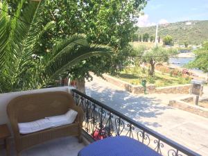 a balcony with a bench and a view of a river at Ammouliani Captain's House in Ammouliani