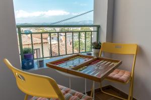 ナフプリオにあるMatina's house vacation rental in Nafplioのテーブルと椅子、バルコニーが備わる客室です。